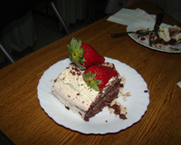 Bolo de chocolate com recheio de flocos e creme com morangos