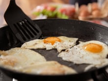 Por que é recomendado colocar vinagre na frigideira ao fritar ovos e qual é o propósito disso?