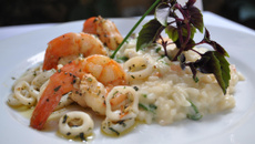 Lulas em anéis com risoto de tomates frescos e rúcula