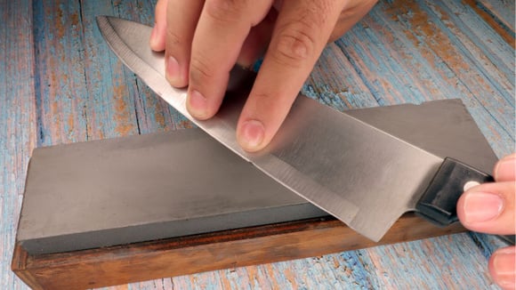 A pedra de amolar ainda é o método mais seguro e eficiente para afiar facas em casa (Créditos: Shutterstock)