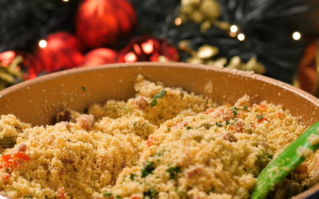 Farofa colorida com temperos sendo misturada em uma panela