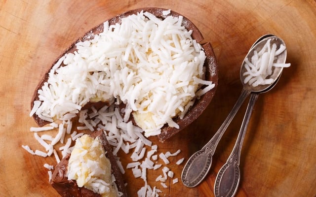 Ovo de Páscoa de bolo de coco gelado finalizado com coco ralado