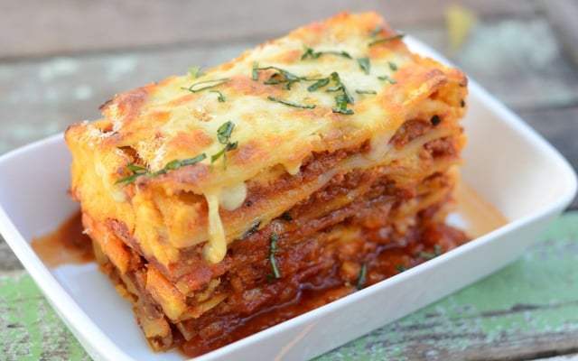 Fatia de lasanha de carne moída com molho bolonhesa em prato