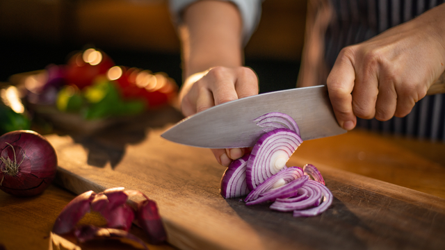 Deixar a raiz da cebola para o final do corte ajuda a reduzir a liberação de compostos irritantes. (créditos: Shutterstock)