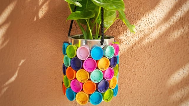 Vaso de plantas feito com tampa de garrafas plásticas (Créditos: Gerado por IA)
