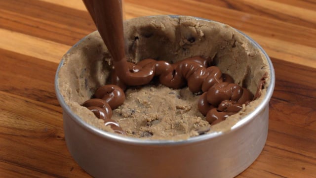 Forma com massa de cookie no fundo e nas laterais e recheio de nutella no meio (Créditos: TudoGostoso)